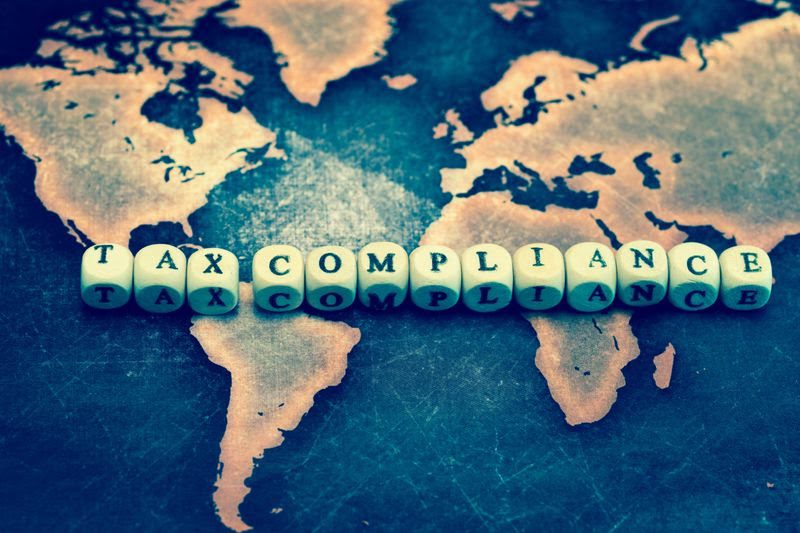 tax compliance concept on world map