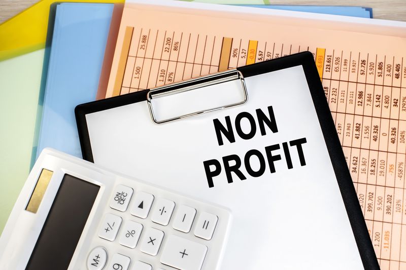 Alt tag: accounting software for nonprofits canada - non-profit stationary board with a white calculator and financial document in the background image