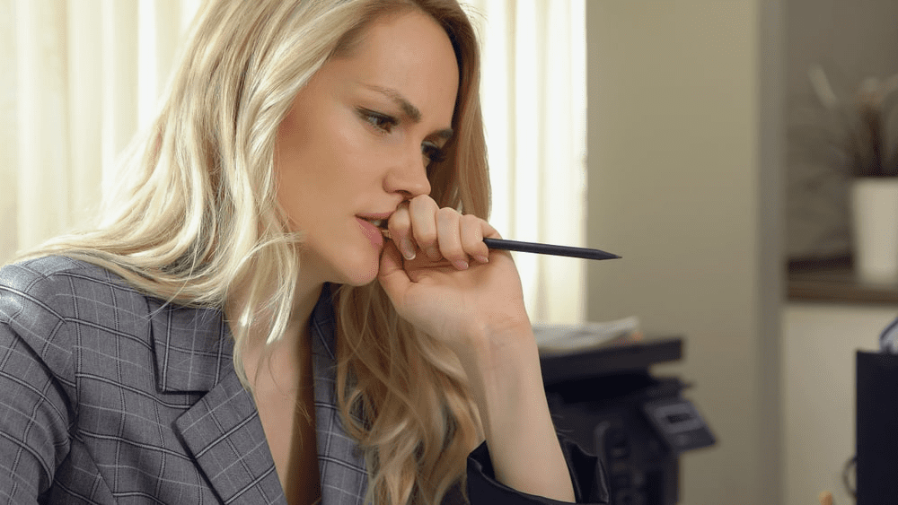 amazon accounting - Woman biting a pen in frustration
