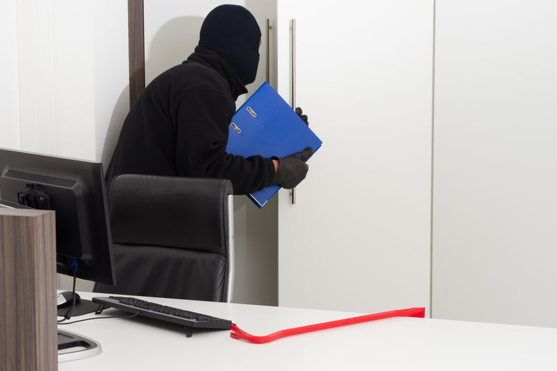 bookkeeping services small business - robber stealing important office documents 