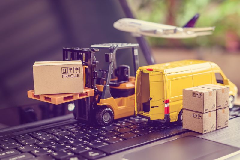 Peachtree software for your online business - toy forklift, truck and airplane on a laptop 