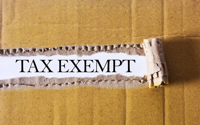 how to set up tax exempt on amazon - A ripped brown carton revealing the word “tax exempt” on white background